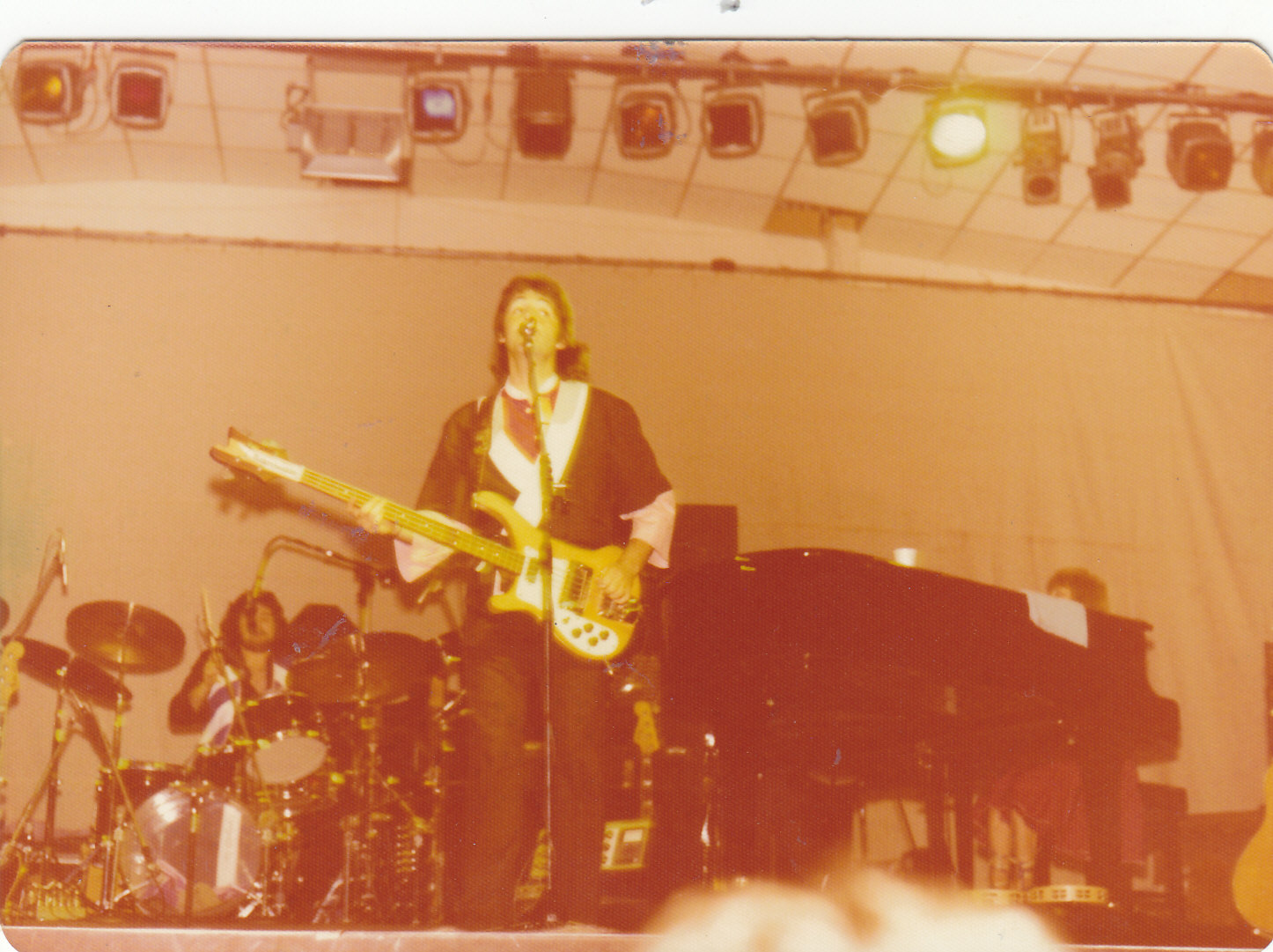 Paul McCartney, live in Adelaide November 1975. Drummer Joe English behind Paul.