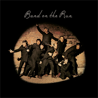Wings album "Band on The Run" cover featuring Wings and friends posing as escaping prisoners.